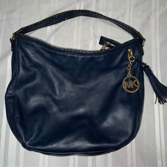 Michael Kors Handbags - Michael Kors hobo bag in blue grain leather with gold-tone and a tassel detail.